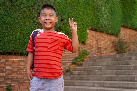 Filipino boy with backpack on the way to school.